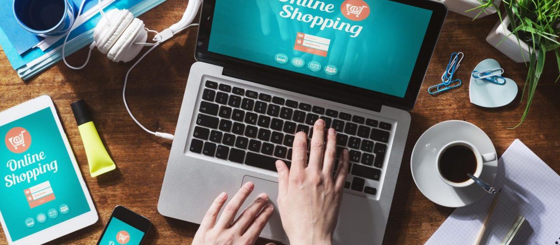 website e-commerce designer working on laptop